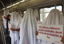 Demonstrators in white sheets are protesting the killings of social leaders in Colombia