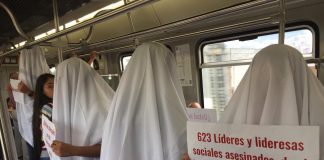 Demonstrators in white sheets are protesting the killings of social leaders in Colombia